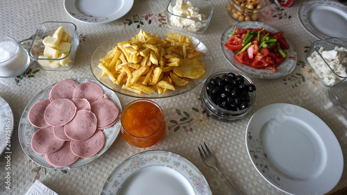 breakfast time  breakfast table french fries  jam  butter  cheese  tea  olives  bread etc ...