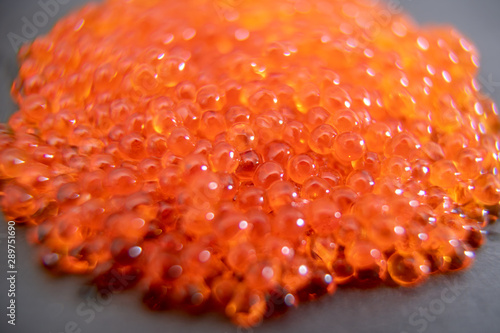 Red caviar close up on the grey stone background