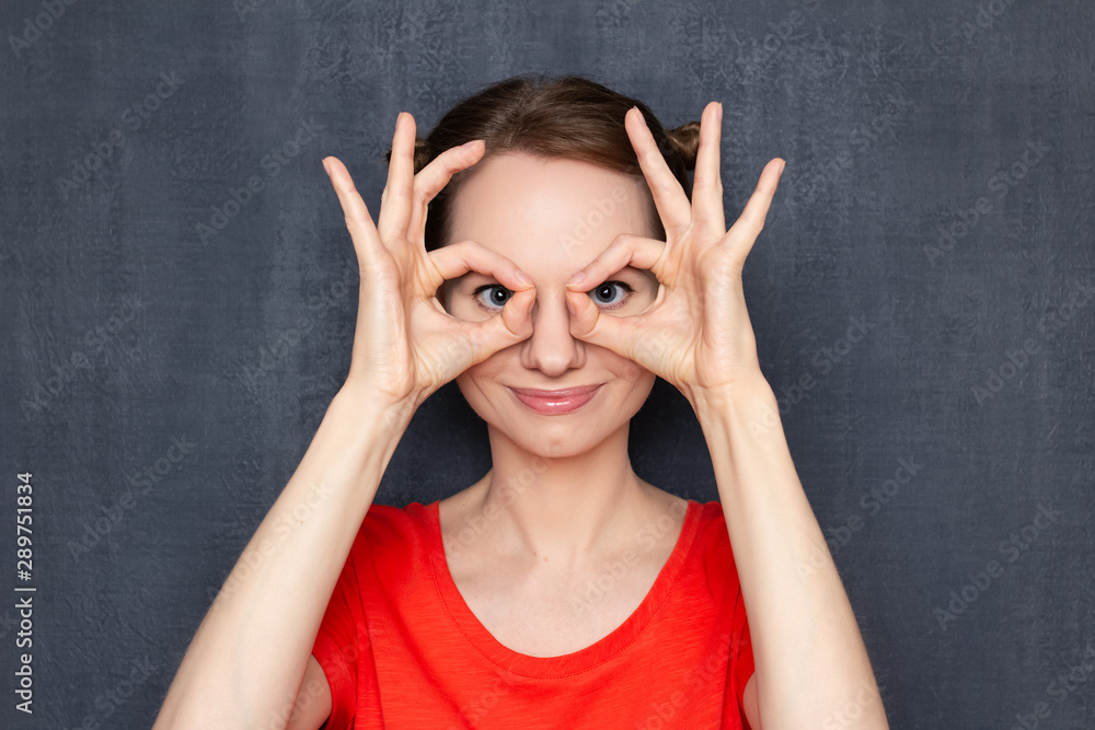 Portrait of happy cute girl making glasses shape with hands Portrait of happy cute girl making glasses shape with hands