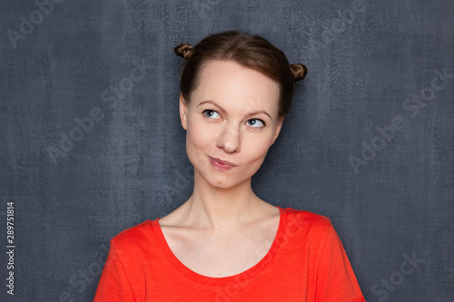 Portrait of happy and dreamy woman with funny hairstyle © Andrei Korzhyts