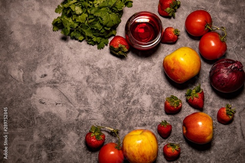 Wallpaper Mural Fresh organic red themed fruit, vegetables, wine, and wooden heart shaped spoon, laying on concrete background countertop. Captured from above.  Torontodigital.ca