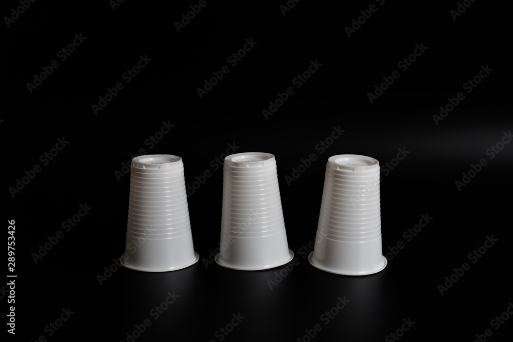 Plastic glasses for drinking on a black background Plastic glasses for drinking on a black background