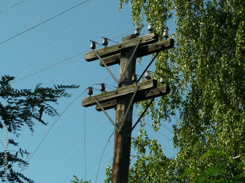 Electric pole from the last century, with dangling wires. Electric pole from the last century, with dangling wires.