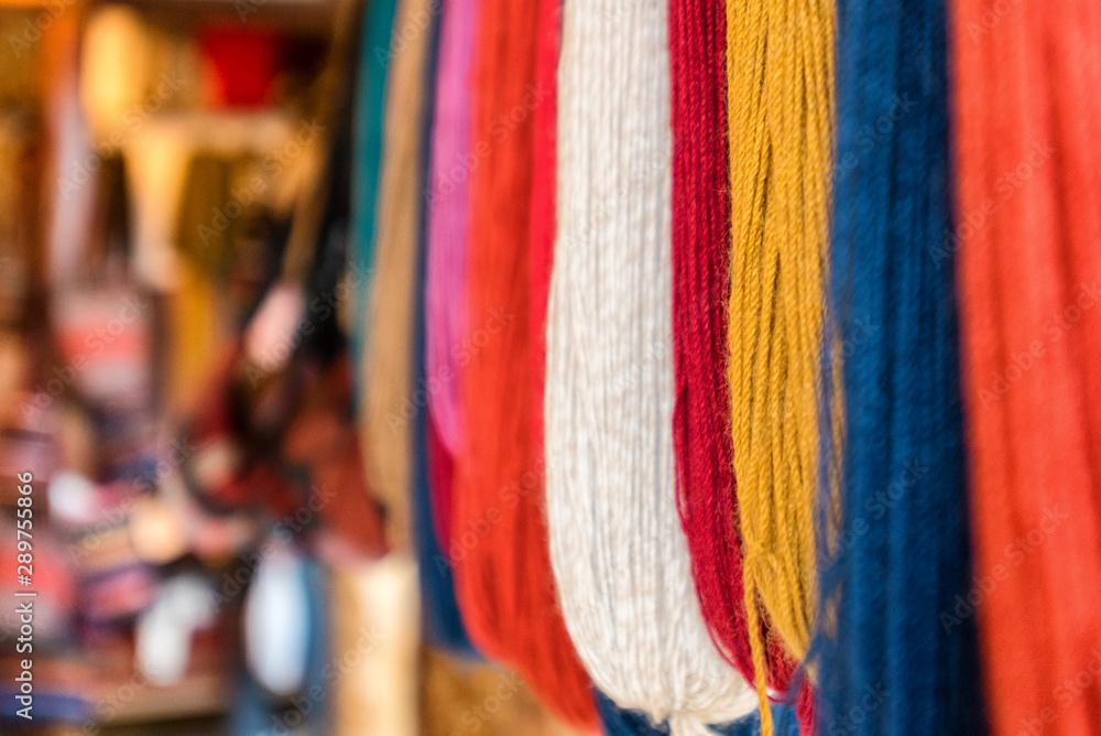Hanging dyed alpaca yarn in multiple colors with focus on foreground