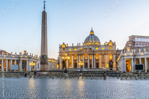 Vatican City by night. Illuminated dome of St Peters Basilica and St Peters Square at the end of Via della Conciliazione. Rome, Italy