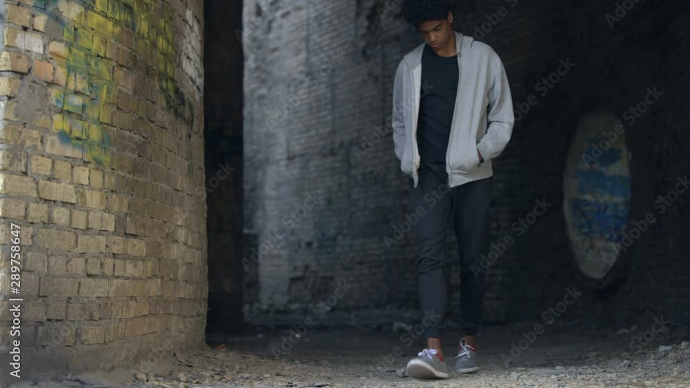 Sad bored young man walking city alone, street lifestyle, troubled teenager Sad bored young man walking city alone, street lifestyle, troubled teenager