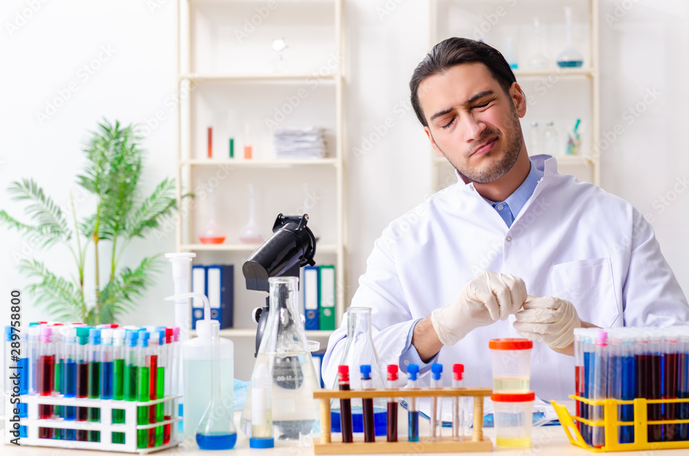 Young male chemist working in the lab Young male chemist working in the lab