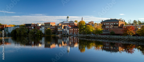 The river front buildings of Exeter, New Hampshire are seen reflected in the water photo