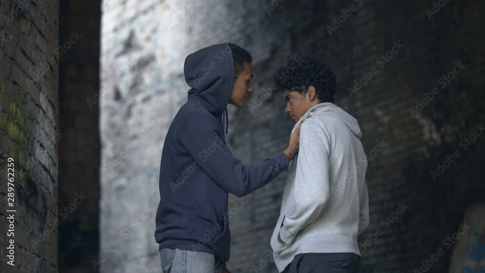 Black college student intimidating scared classmate hitting, teenage bullying Black college student intimidating scared classmate hitting, teenage bullying