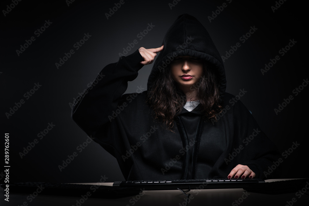Female hacker hacking security firewall late in office Female hacker hacking security firewall late in office
