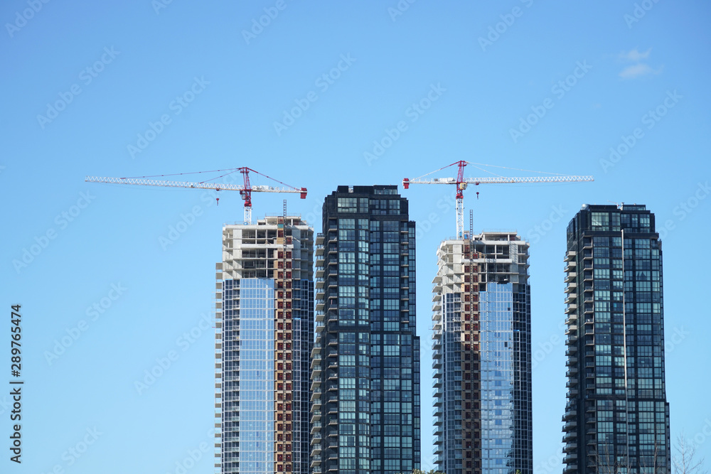 skyscraper building under construction with crane at construction site skyscraper building under construction with crane at construction site