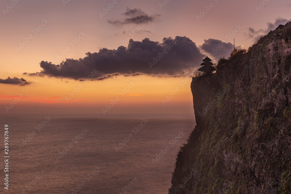 Sunset view over the sea from Uluwatu temple, Bali island Sunset view over the sea from Uluwatu temple, Bali island