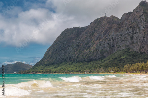 Beautiful Waimanalo beach with turquoise water and cloudy sky, Oahu coastline, Hawaii © Dmitrii