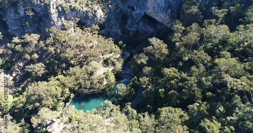 Blue lake on Jenolan river near Charlotta arch between high sandstone mountain ranges in Australian Blue Mountains – famous for karst caves. photo