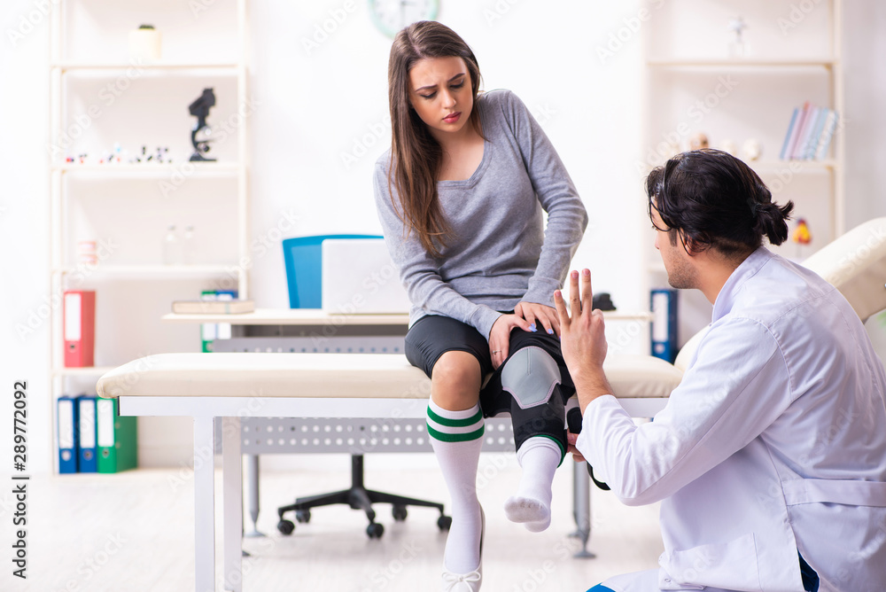 Fototapeta premium Young male doctor and female beautiful patient