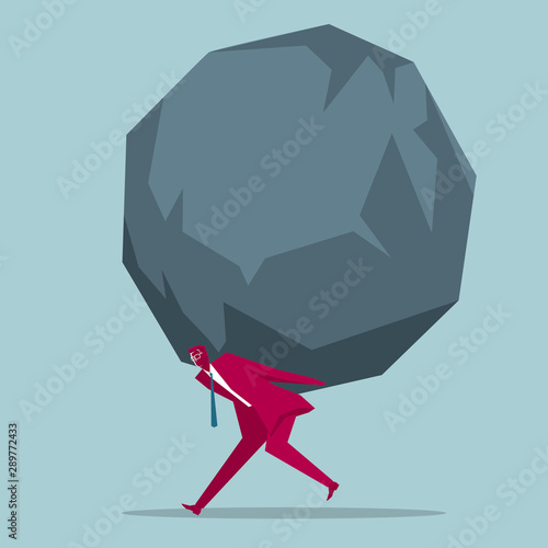 Businessman carrying huge stones. Isolated on blue background.