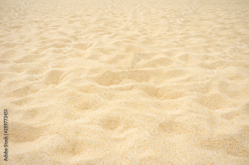 Close up Beach sand in summer sun smooth texture as beautiful background.