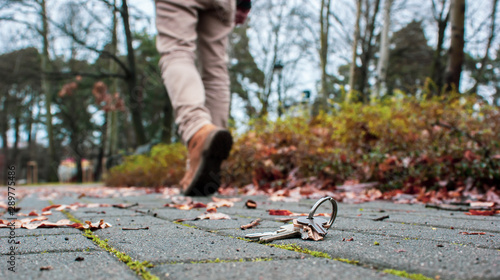 Fotografie Man walking away from lost home keys