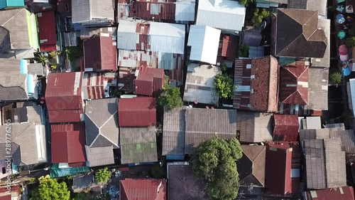 Aerial view of a local village in Bangkok with the Buddhist temples in the background. Area by the Chao Phraya river, the most important river in Thailand.