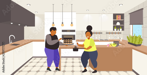 fat obese coupe cooking sweet homemade dessert overweight man woman cooking cake unhealthy nutrition obesity concept modern kitchen interior flat full length horizontal