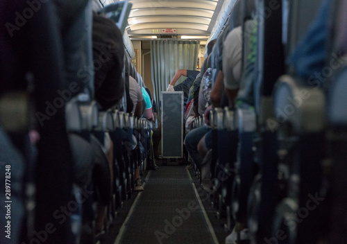Blurred photo of the aircraft interior. Passengers in the cabin airplane © warloka79
