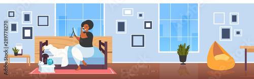 fat obese woman applying black mascara african american girl looking at mirror touching eyelashes using tassel making professional make up modern bedroom interior flat full length horizontal