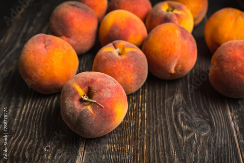 Sweet ripe peaches on the rustic background. Selective focus. Shallow depth of field.