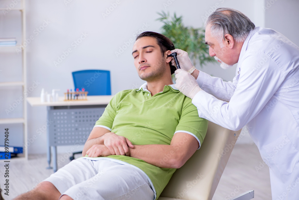 Fototapeta premium Male patient visiting doctor otolaryngologist