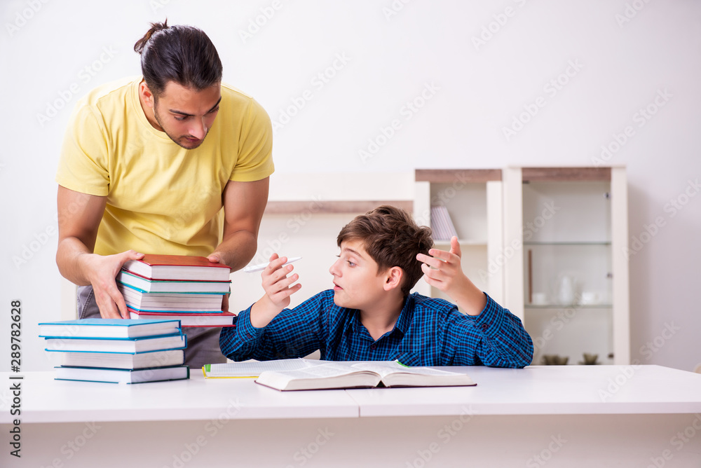 Father helping his son to prepare for school Father helping his son to prepare for school
