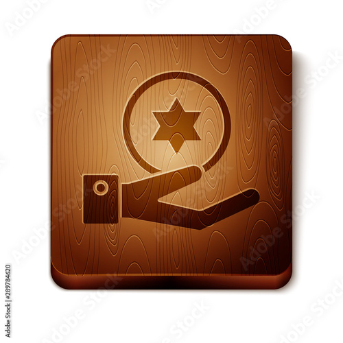 Brown Jewish coin on hand icon isolated on white background. Currency symbol. Wooden square button. Vector Illustration