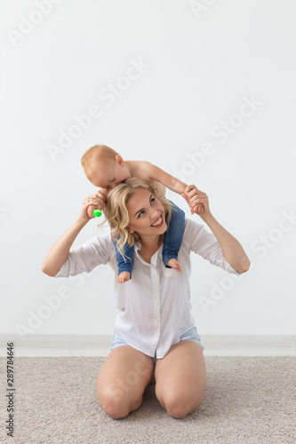 Cute single mother and kid girl playing together indoor at home