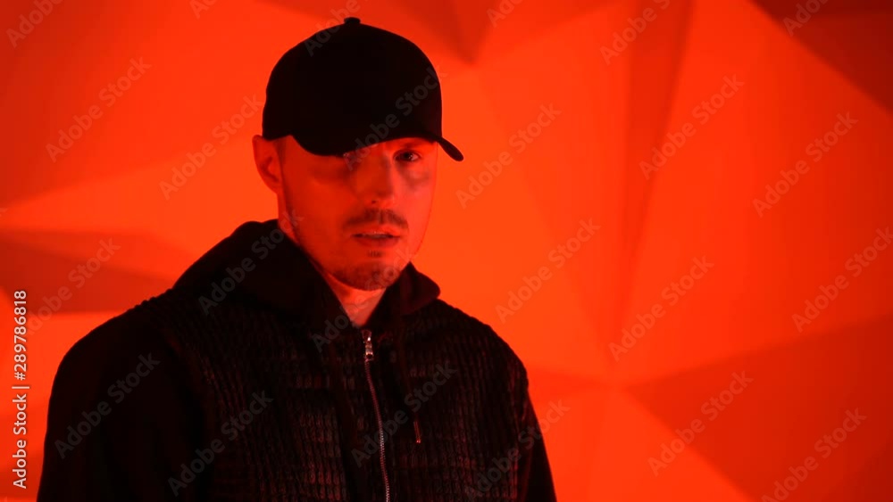 Rapper guy rap in front of the camera on a red background Rapper guy rap in front of the camera on a red background