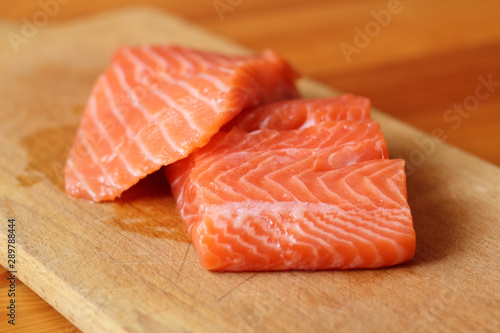 Raw Humpback Salmon Fillet on cutting board (soft focus)