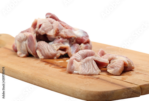 Raw Chicken gizzards on cutting board