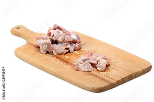 Raw Chicken gizzards on cutting board