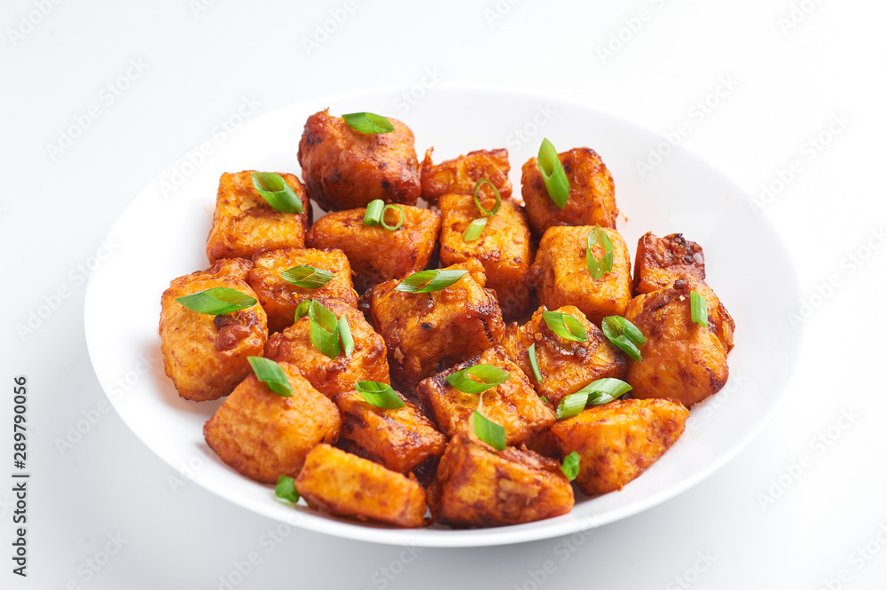 Paneer Manchurian or Paneer 65 isolated on white background. Paneer Manchurian is Indian Chinese cuisine dish with panner cheese, tomatoes, onion, soy sauce. Paneer Manchurian or Paneer 65 isolated on white background. Paneer Manchurian is Indian Chinese cuisine dish with panner cheese, tomatoes, onion, soy sauce.