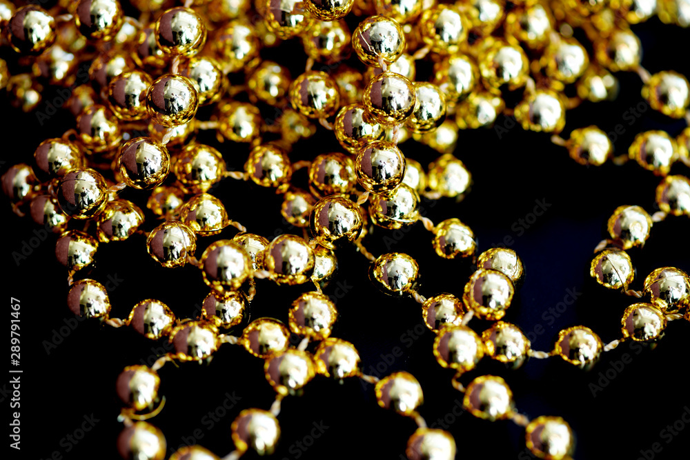 Golden christmas decoration on a dark surface close up. Abstract background Golden christmas decoration on a dark surface close up. Abstract background