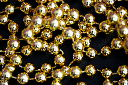 Golden christmas decoration on a dark surface close up. Abstract background