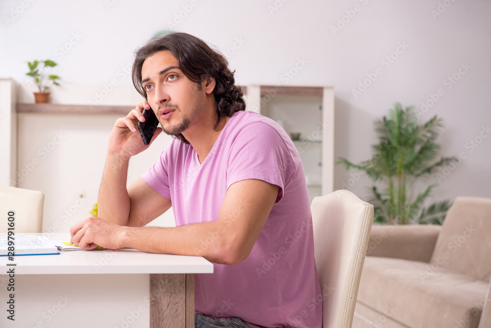Young male student preparing for exams at home Young male student preparing for exams at home