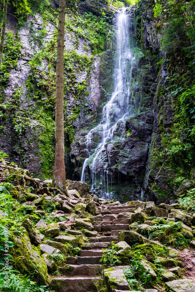 Germany, Stone steps to magic black forest waterfall called burgbachwasserfall in green paradise like scenery in untouched nature landscape