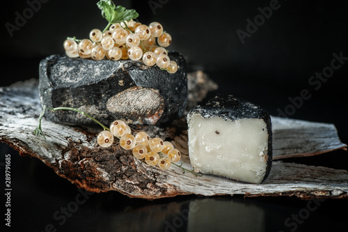 Turgau hard cheese is a fine hard Swiss cheese with the aroma of onion bread. Cheese is produced in the Canton of Thurgau on lake Constance. Head cheese garnished with berries of white currant photo