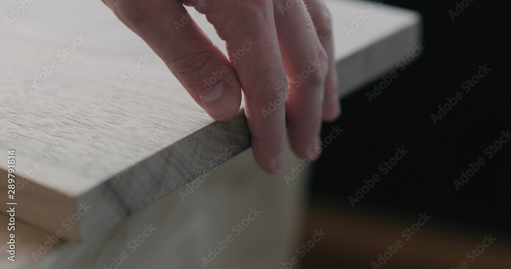 Obraz premium woodworker touching untreated black walnut board