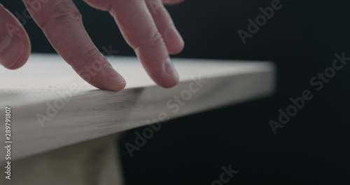 woodworker touching untreated black walnut board
