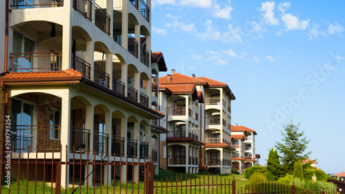 facade of modern hotel apartments against the blue sky on a sunny day