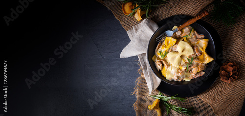 Colorful farfalle pasta with chanterelles and cream sauce.