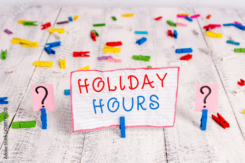 Handwriting text writing Holiday Hours. Conceptual photo employee receives twice their normal pay for all hours Scribbled and crumbling sheet with paper clips placed on the wooden table