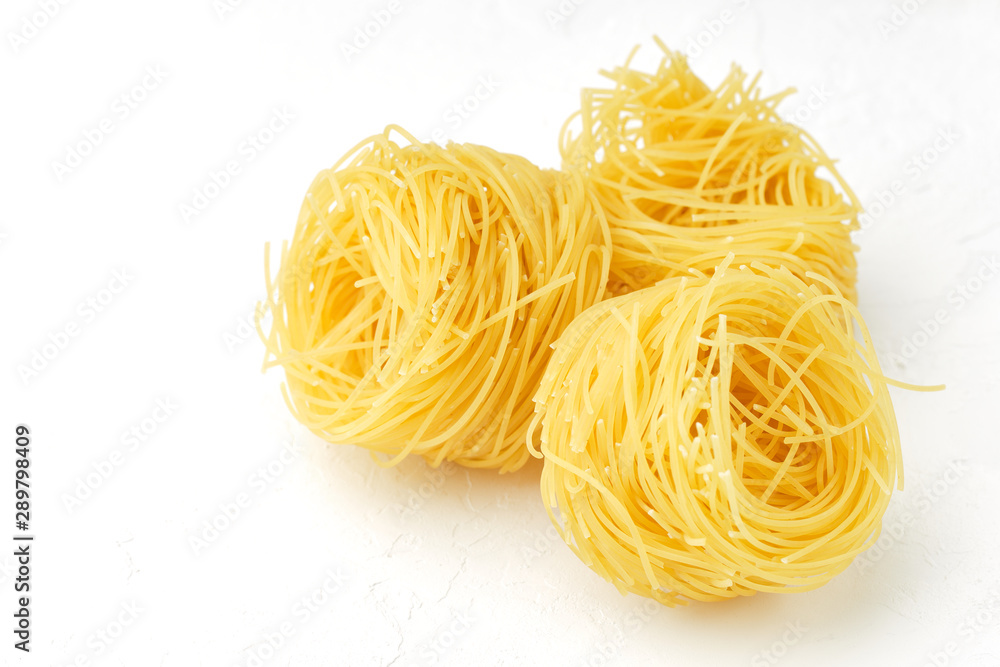 raw pasta capellini isolated on white background raw pasta capellini isolated on white background