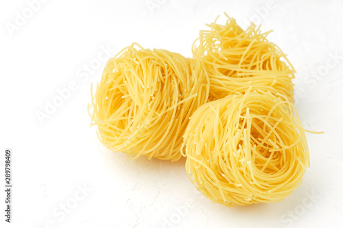 raw pasta capellini isolated on white background