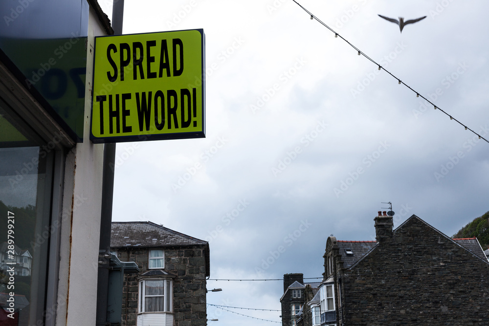 Obraz premium Writing note showing Spread The Word. Business concept for share the information or news using social media Green ad board on the street with copy space for advertisement