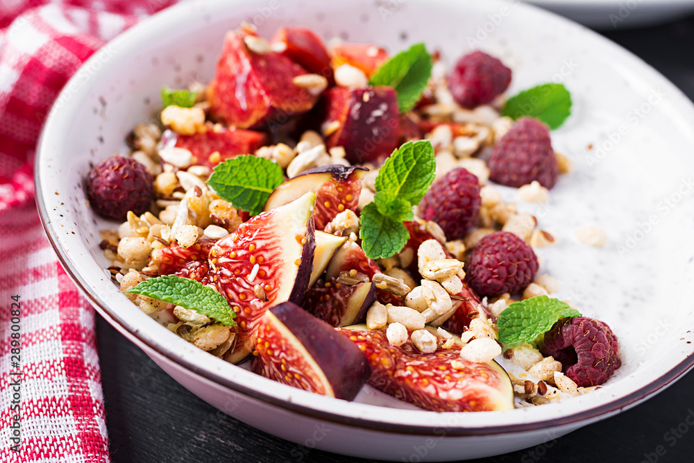 Chia seed pudding made with raspberries, figs and mint on dark background. The concept of good nutrition. Chia seed pudding made with raspberries, figs and mint on dark background. The concept of good nutrition.